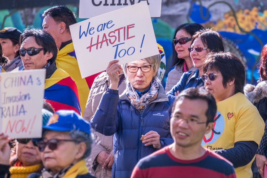 An anti-China protester holds a sign that reads 'We are Hastie too'
