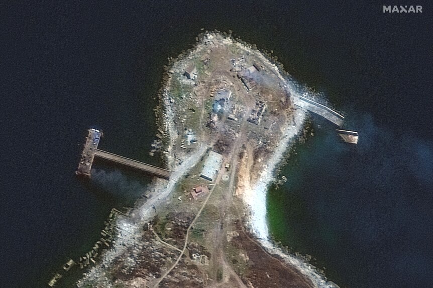 Close up satellite image of Snake Island showing burning buildings.
