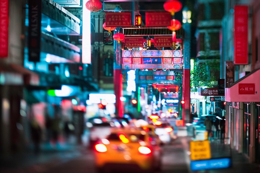 Slightly blurred photo shows night street scene in Melbourne's Chinatown.