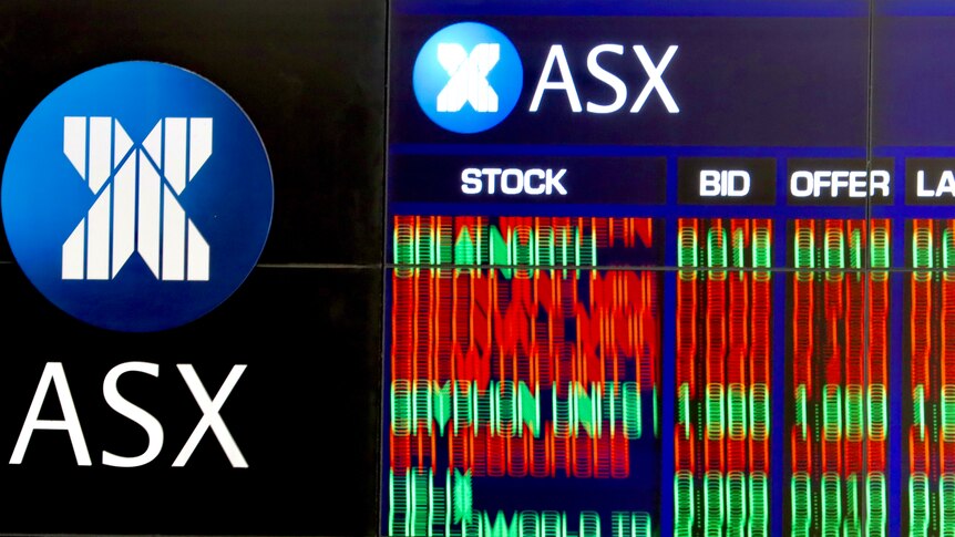 A blurred photo of the share trading boards at the Australian stock exchange 