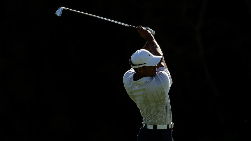 Tigers Woods against a black background in second round of 2011 Aust Open
