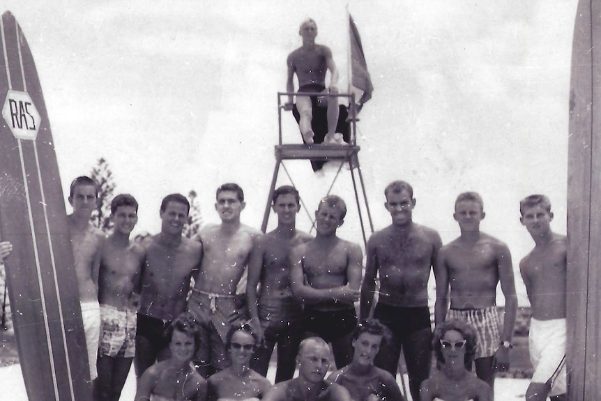 Black and white photo of shirtless surfers in the 1950s