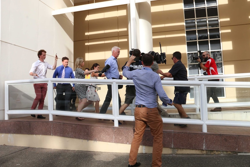 John McRoberts is trailed by the media as he leaves the court house