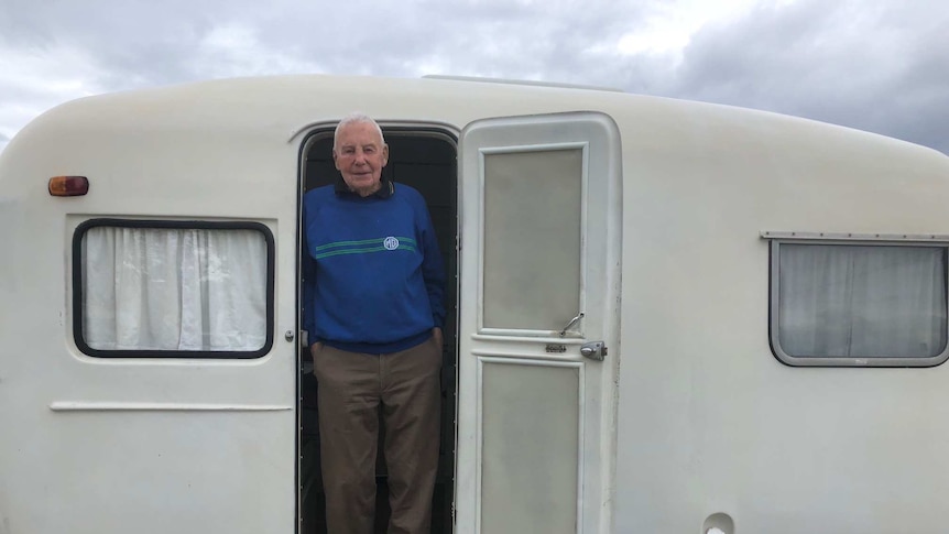 Claude Harris standing at the door in his Sunliner caravan at the 60th Anniversary gathering in Forster