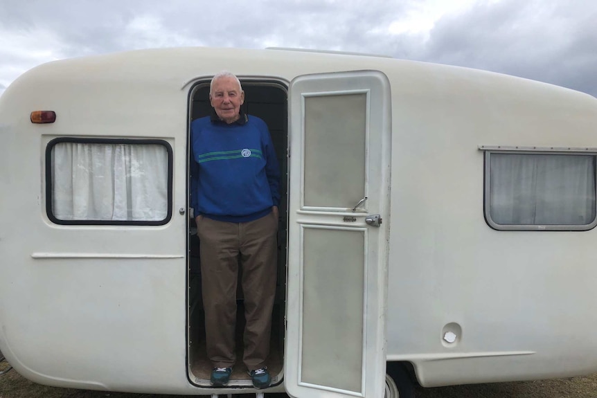 Claude Harris standing at the door in his Sunliner caravan at the 60th Anniversary gathering in Forster