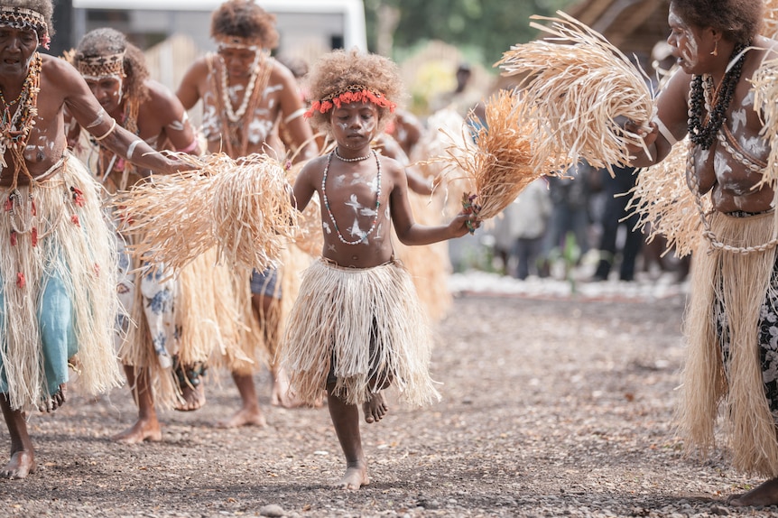 Young dancers in traditional Solomon Island dress perform.