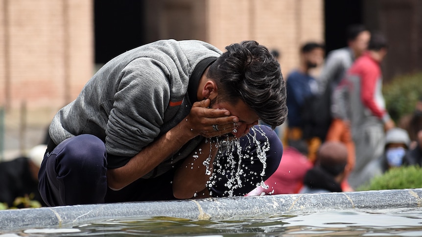 A Muslim man washes his face with water before prayer in a mosque in Kashmir. 