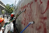 Clean-up: Volunteers scrub Red Shirt graffiti from an area occupied by protesters in Bangkok