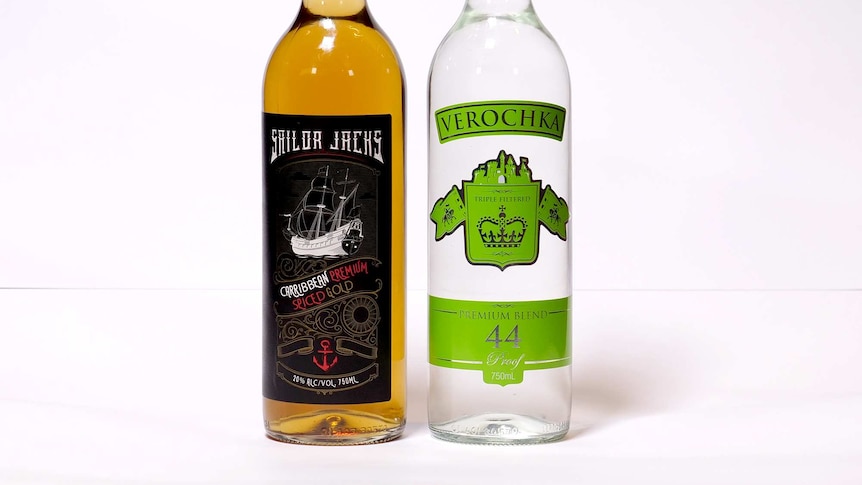 Two bottles of alcoholic drinks, one brown and another clear, with labelling that suggests contains rum and vodka