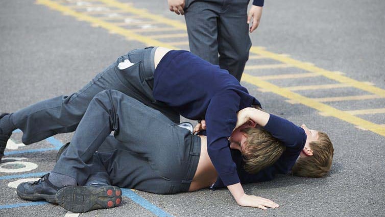 Kids fighting in a schoolyard