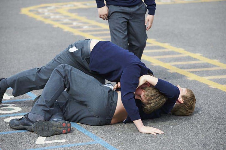 Kids fighting in a schoolyard