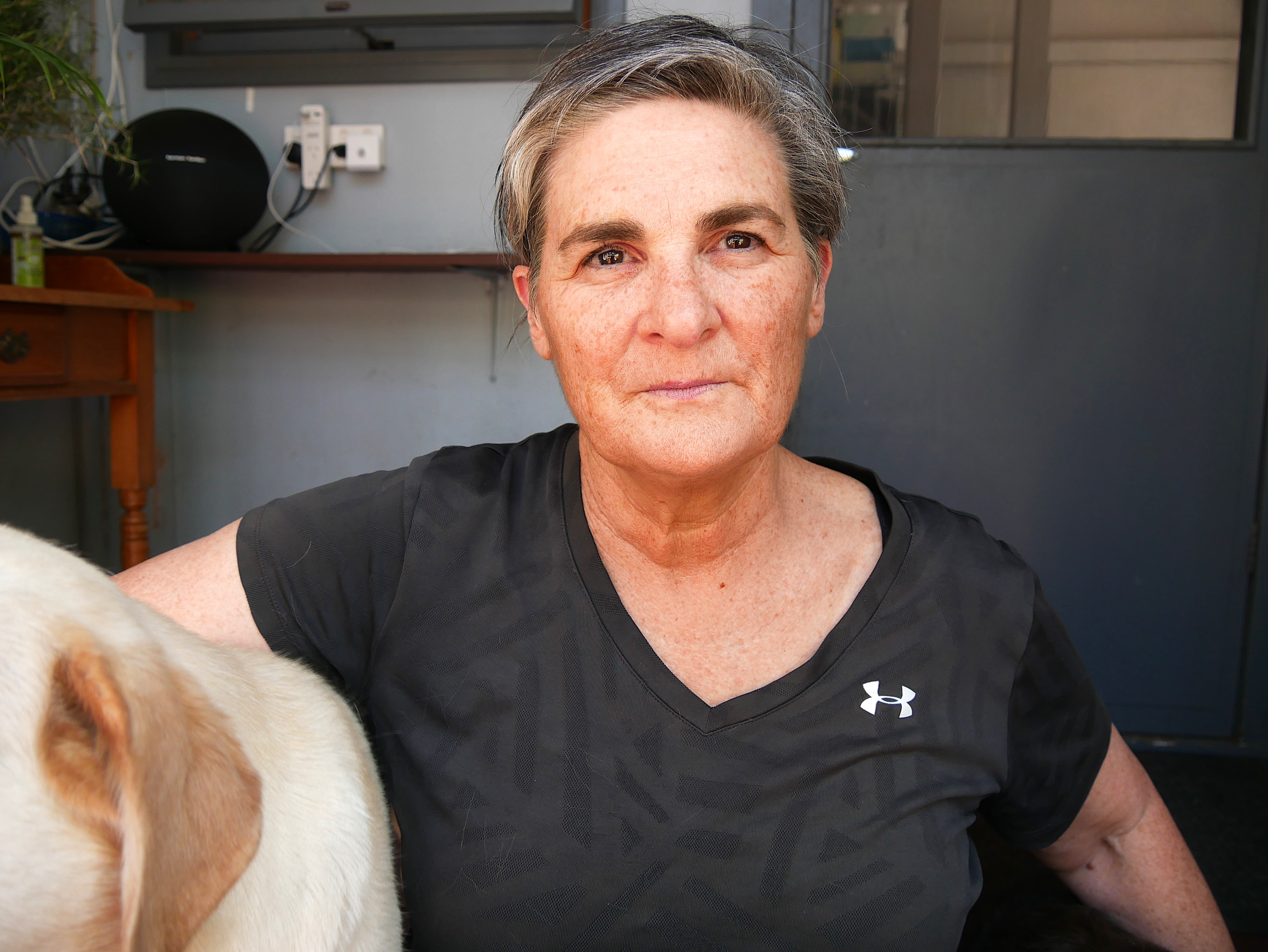 a grey-haired woman looking at the camera