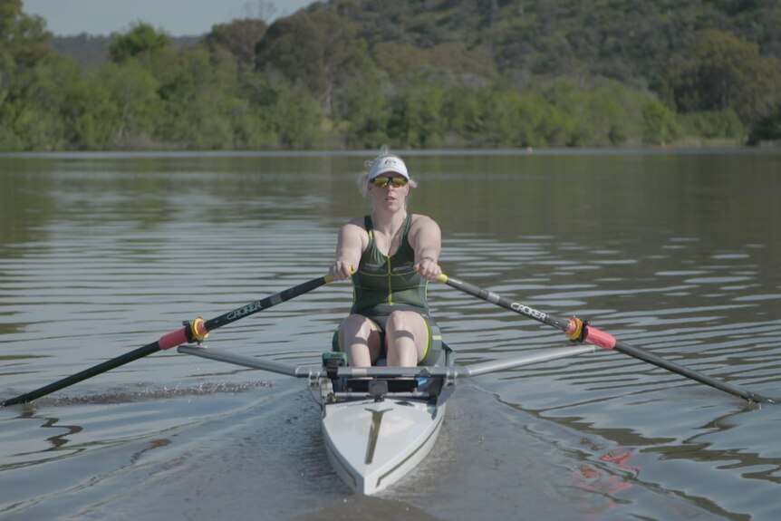 Rower in a canoe on the water.