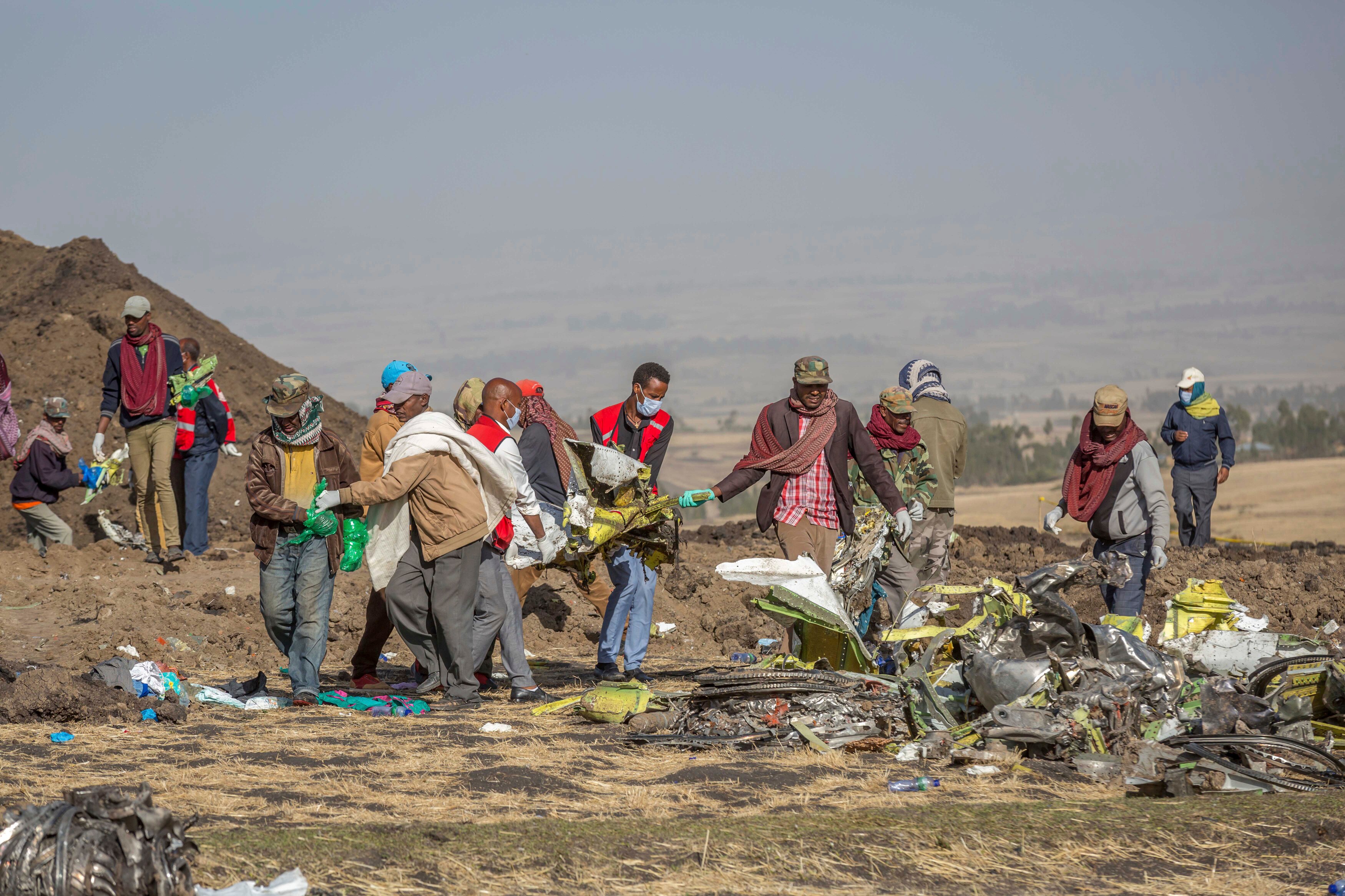 People clearing debris from a field 