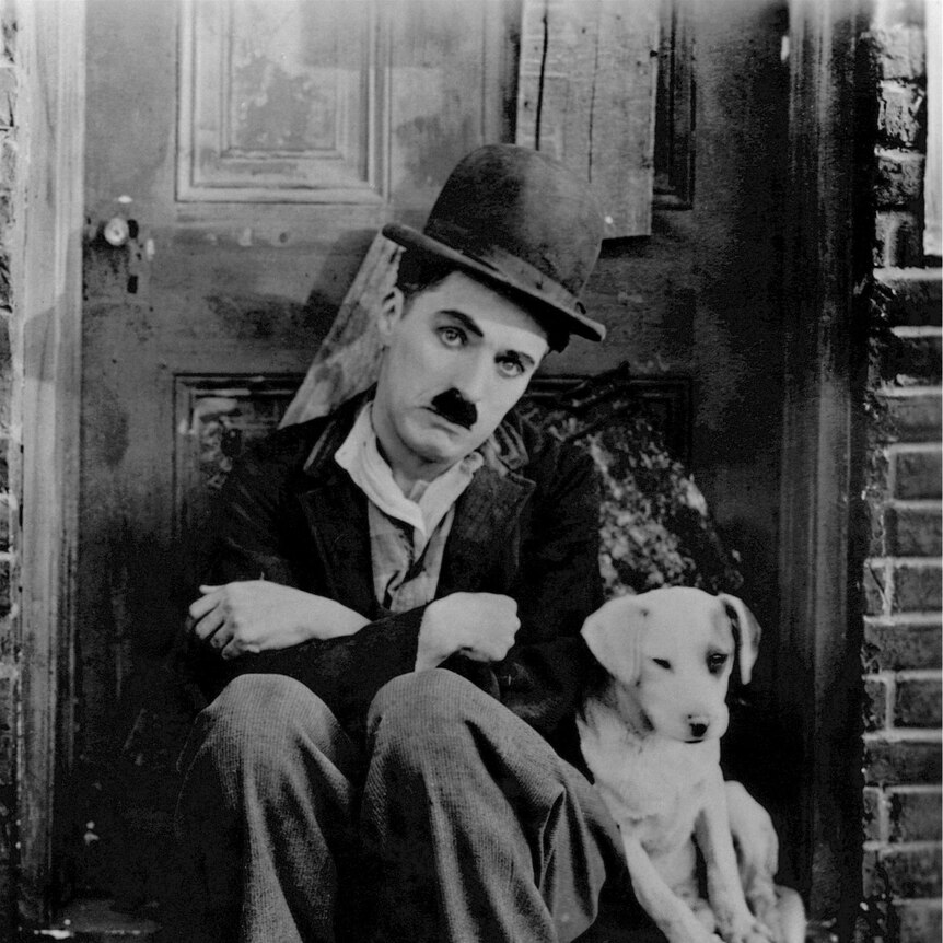 Charlie Chaplin pictured in his famous screen persona of “The Tramp”