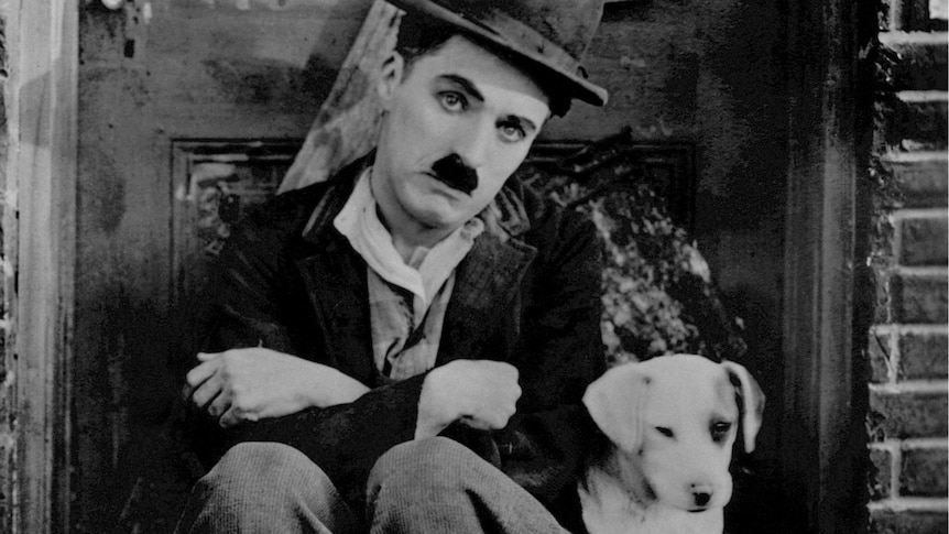 Charlie Chaplin pictured in his famous screen persona of “The Tramp”