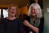 Greens Senator Janet Rice and her partner Penny Whetton laugh at the camera.
