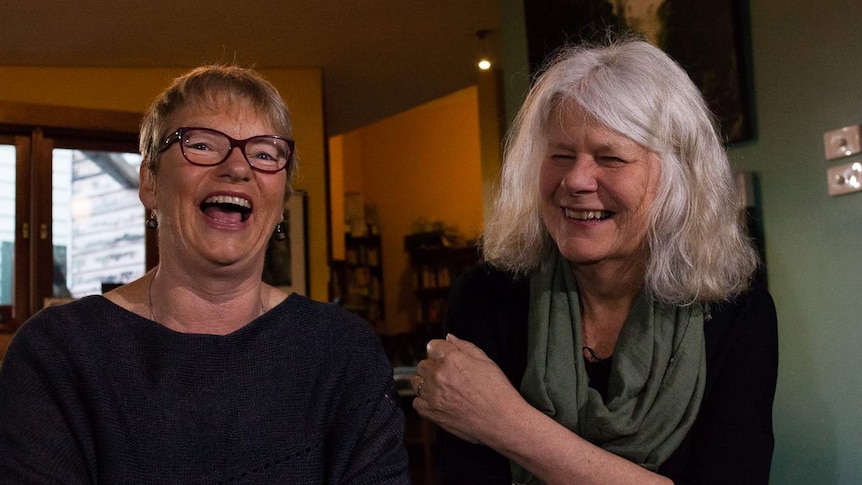 Greens Senator Janet Rice and her partner Penny Whetton laugh at the camera.