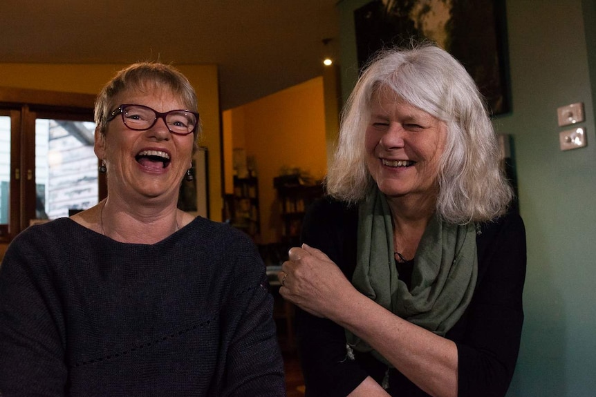 Greens Senator Janet Rice and her partner Penny Whetton laugh at the camera.