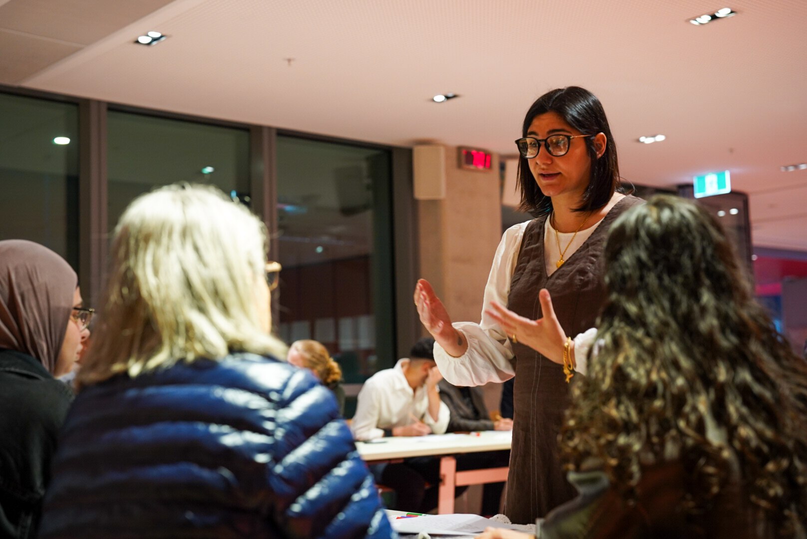 Zeinab Mahfoud organiser of The Villages We Carry event speaks to a group of people