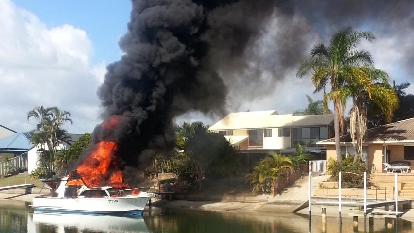 Flames and smoke pour from a boat at Paradise Point after explosion.