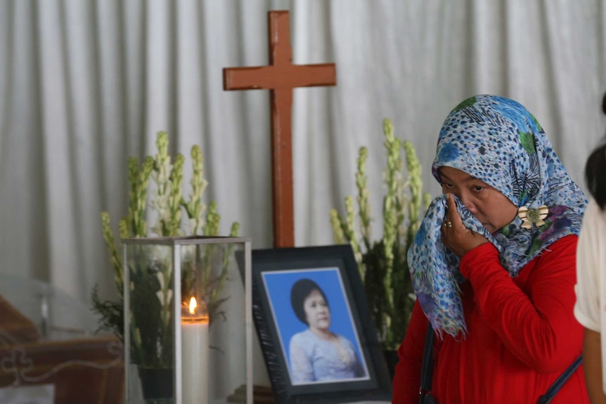 A Muslim woman weeps during the wake of a bombing victim