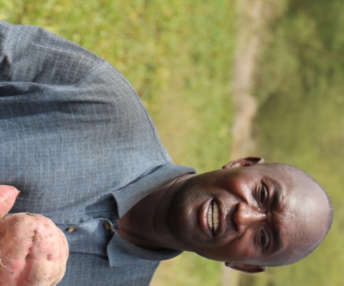 A man standing with sweet potatoes