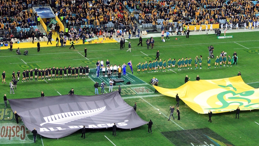 The Wallabies and All Blacks line up for the national anthems before the first Bledisloe Cup match.
