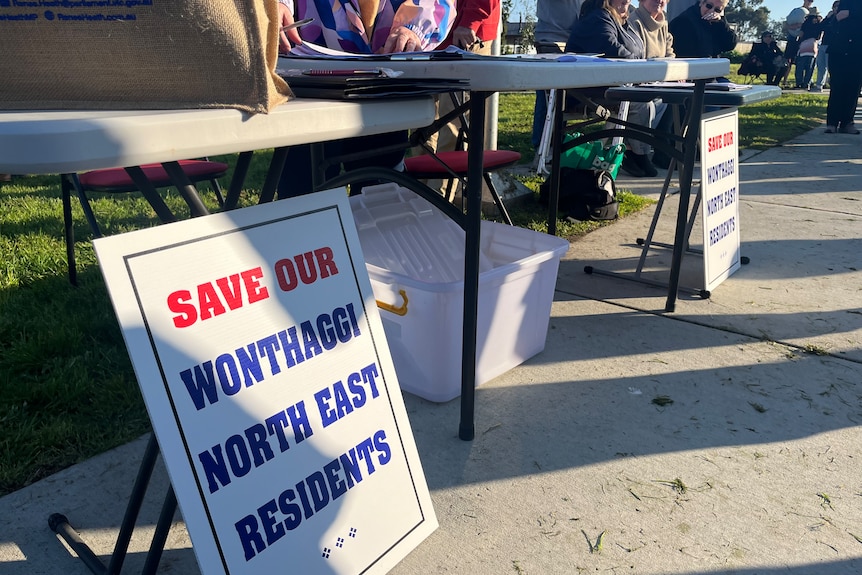 Signs near table stating "Save our Wonthaggi North East Residents"