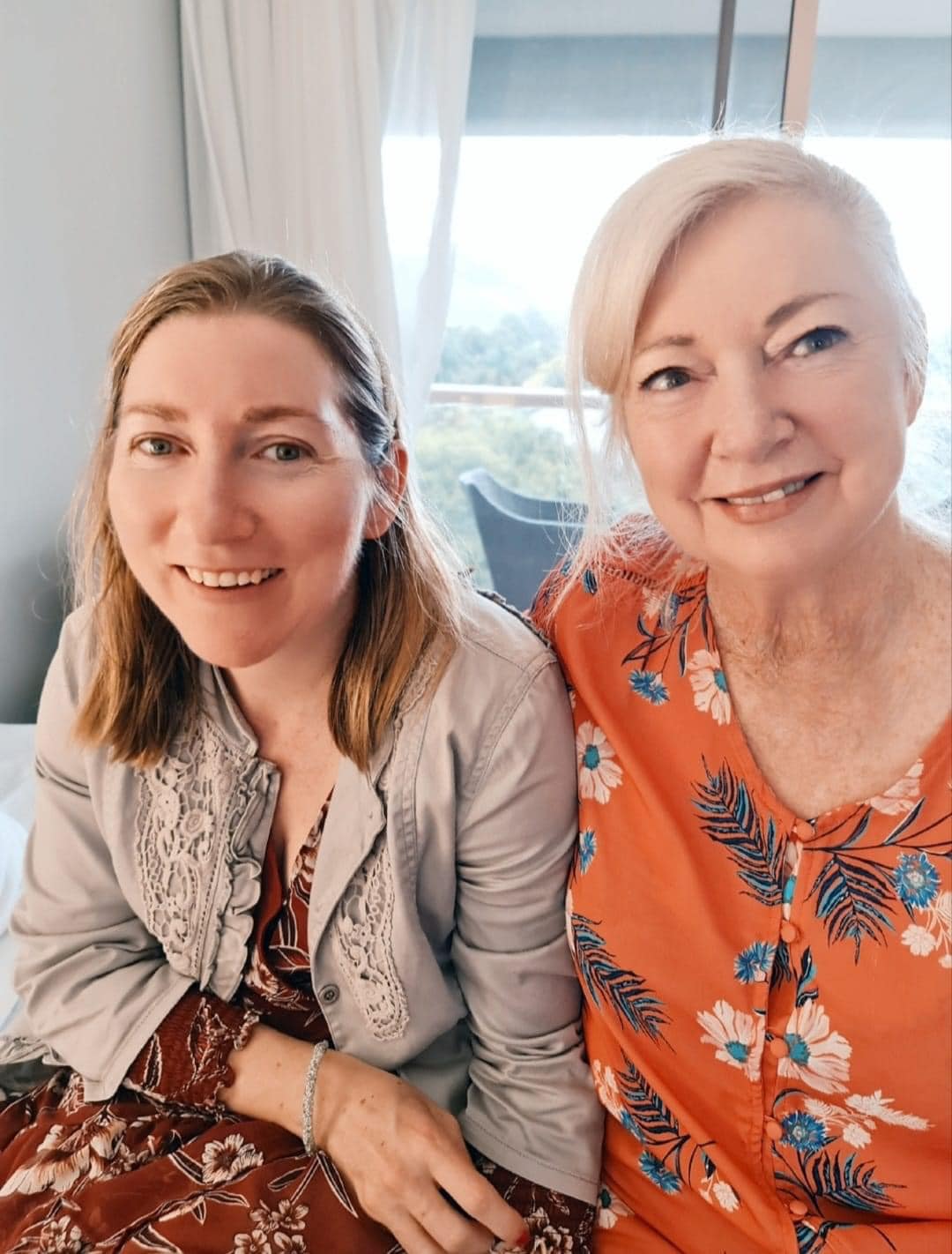 A mother and daughter smile