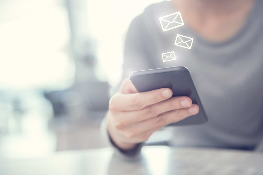 Portrait of woman checking phone with multiple emails.