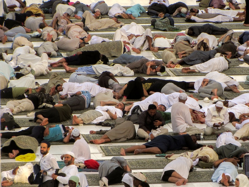 Muslim pilgrims lying down and taking a nap 