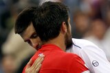 Novak Djokovic hugs Janko Tipsarevic after Tipsarevic retired in their match at the US Open