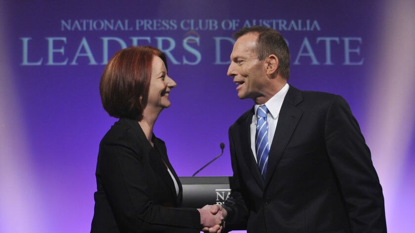 Julia Gillard and Tony Abbott shake hands ahead of the Federal Election leaders' debate.