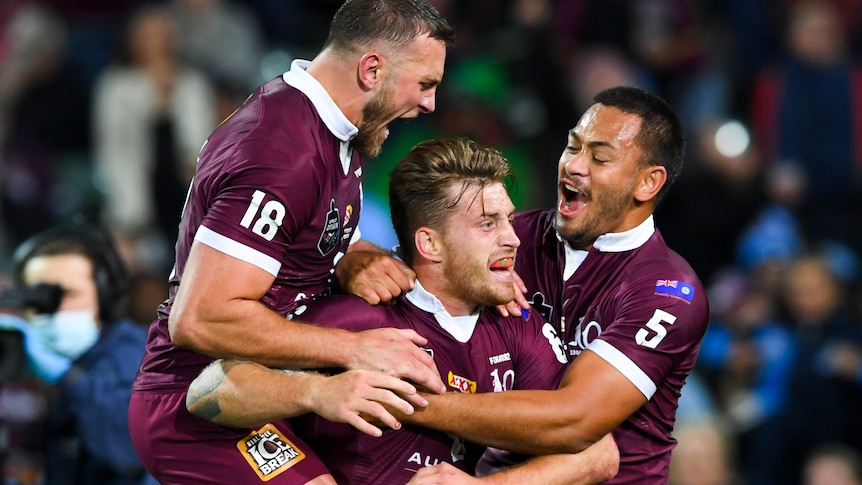 Cameron Munster is hugged by two players