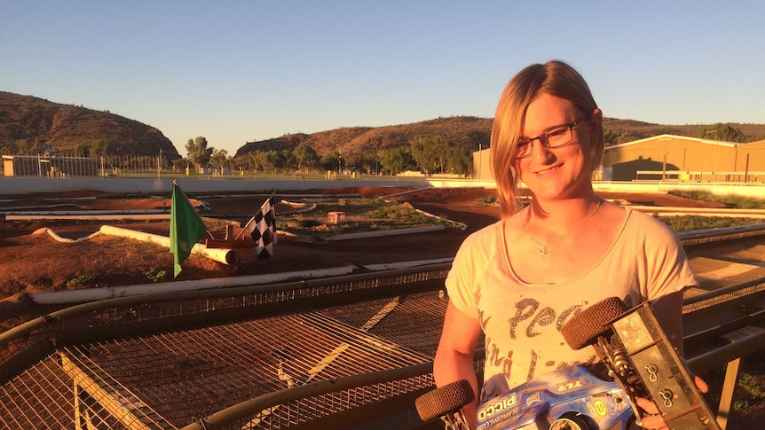 Transgender woman Nicole holds a remote control car.