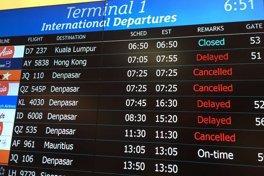 Departures board at Perth Airport showing cancelled flights to Bali.