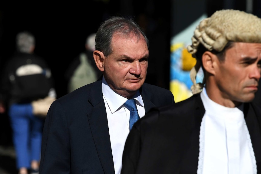 Former Ipswich mayor Paul Pisasale wearing a suit arrives at the District Court in Brisbane.