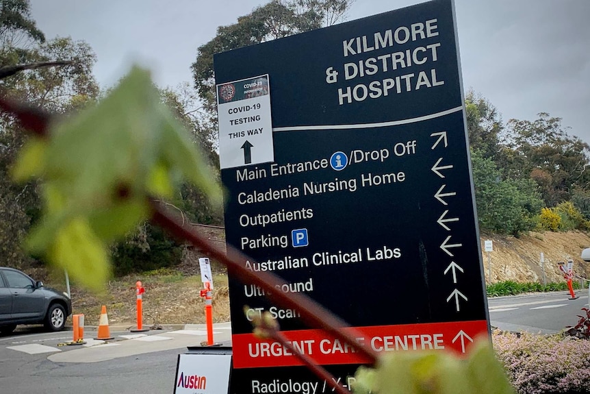A large outdoor sign points people towards different parts of Kilmore and District Hospital.