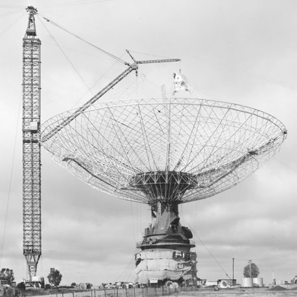 A black and white image of the radio telescope being built