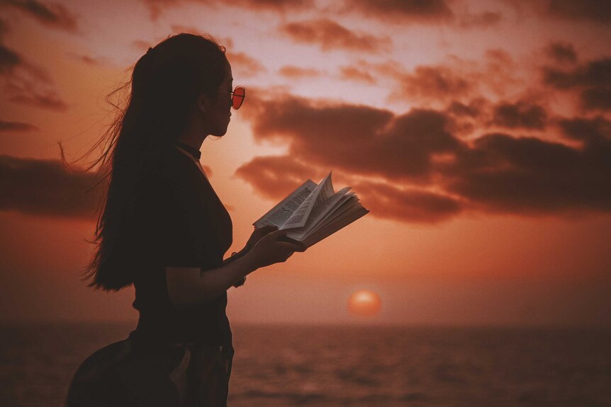 Woman reading in the sunset