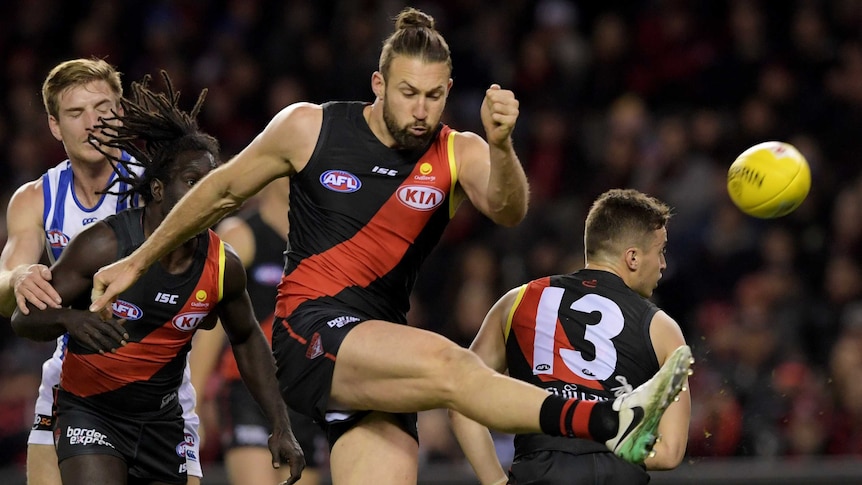 Cale Hooker kicks a goal for the Bombers