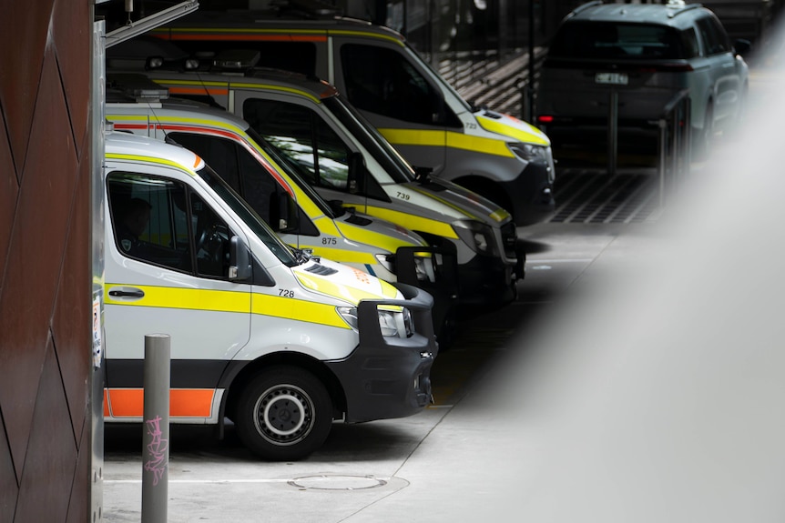 Ambulances in a line in an underground driveway