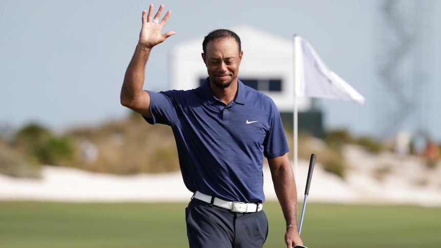 Tiger Woods waves after his second round at the World Challenge golf tournament on December 2, 2016.