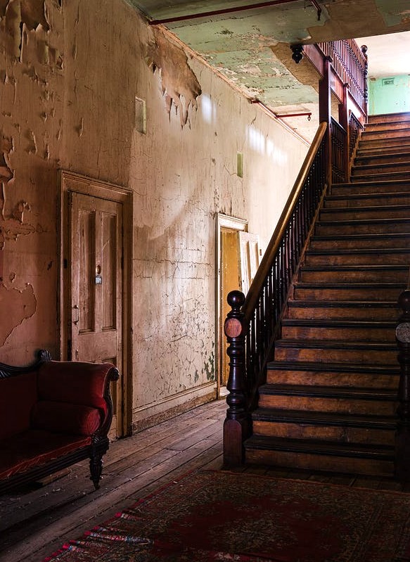 A staircase at a rundown home.