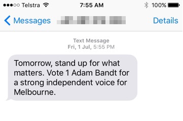 A screenshot of a text message which encourages the receiver to "vote 1 Adam Bandt".