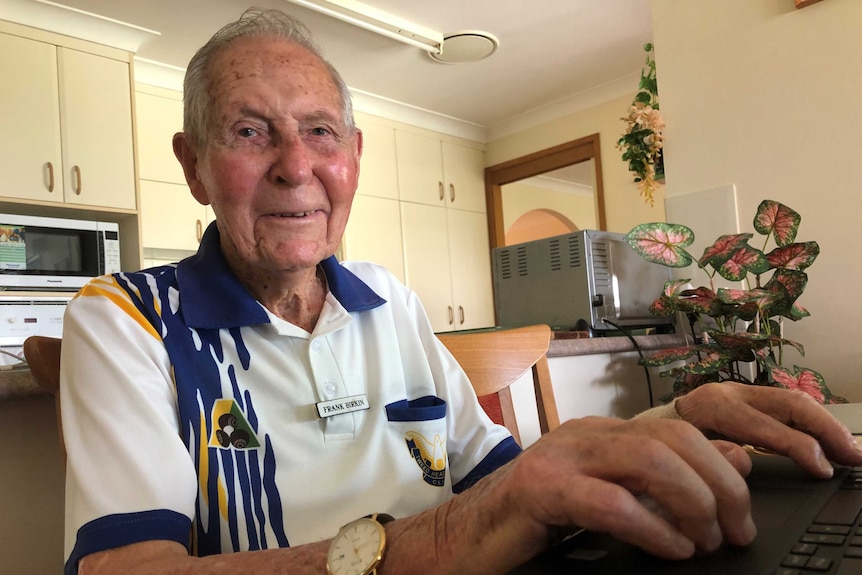 Frank Birkin is 101 years old and is sitting at a table using his computer