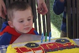 Missing child William Tyrrell blows out candles on a cake on his third birthday.