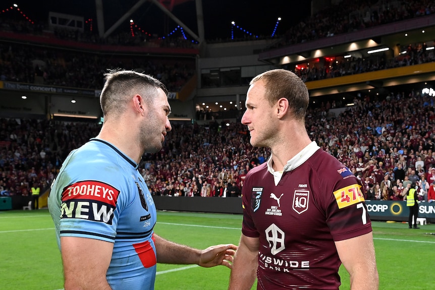 Two men talk after a rugby league match