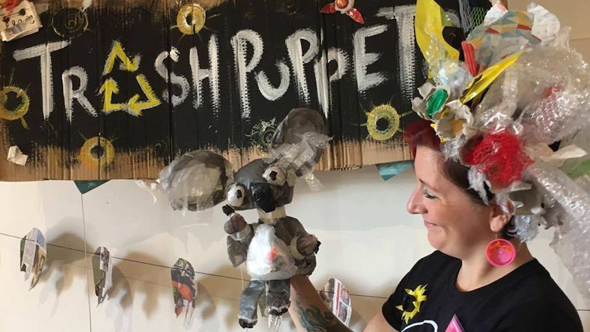 Puppeteer Jhess Knight showing one of her sock puppets created with trash.
